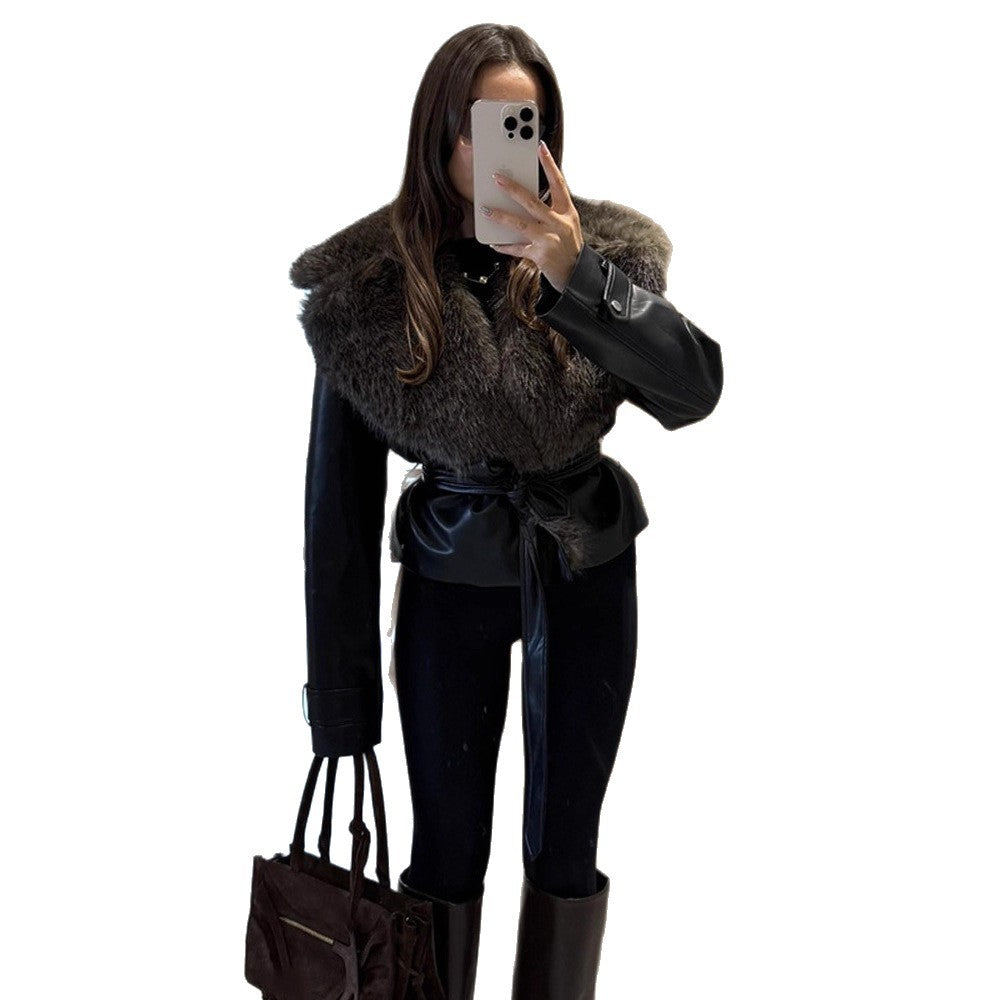 Women's short jacket in biker blouson style made of imitation leather with voluminous faux fur shawl collar and waist belt Mune Fashion