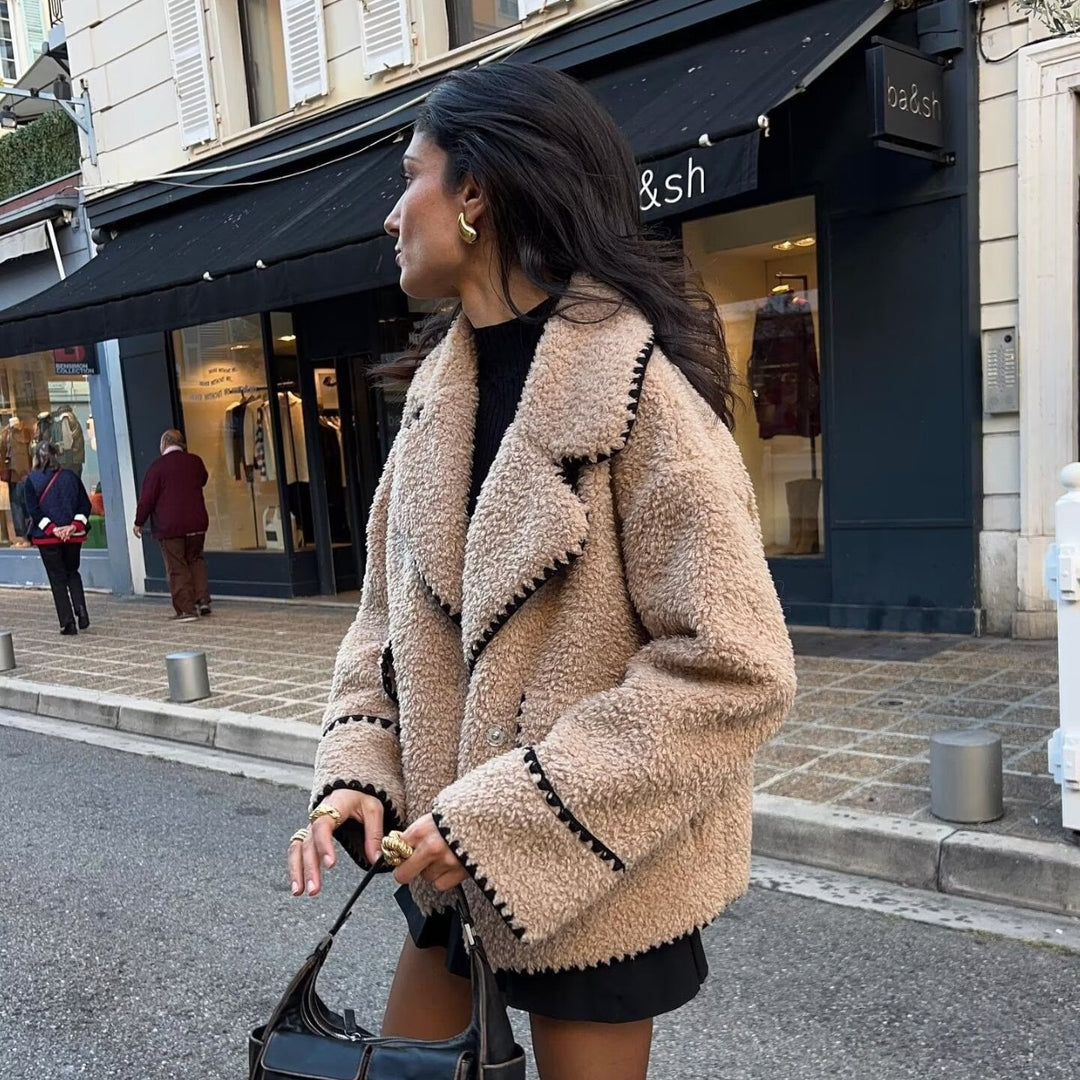 Women’s short cut teddy coat with large shawl collar, patch pockets, and contrasting decorative trim Mune Fashion
