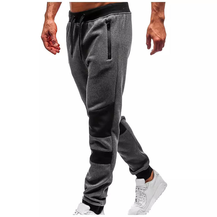Men's slim-fit jogging pants with zip pockets, elastic comfort waistband, and reinforced knee panels Mune Fashion