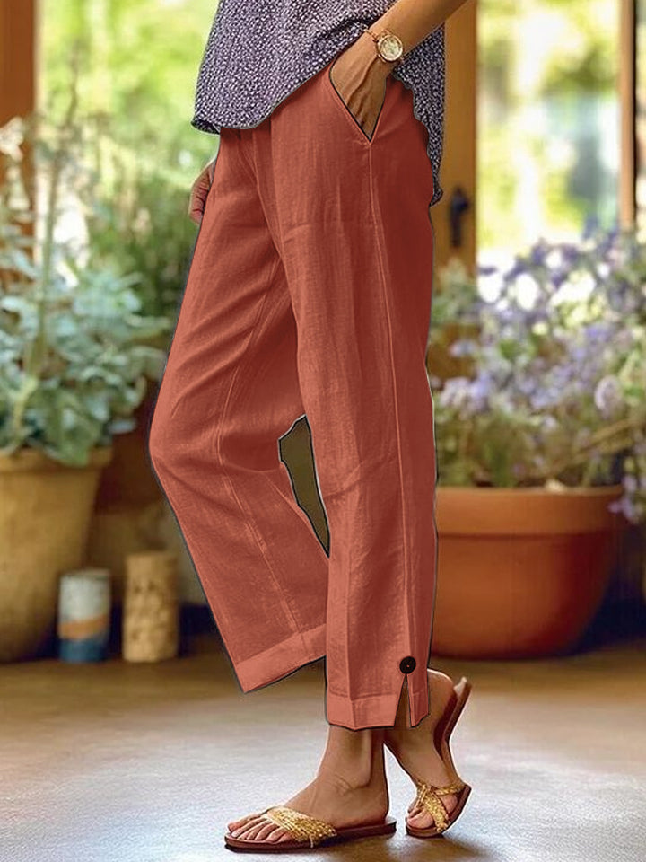 Women's linen trousers with a relaxed, ankle-length fit, side pockets and decorative button details Mune Fashion