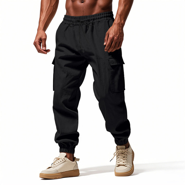 Men's tapered joggers in utilitarian style with elastic waistband, drawstring, and flap pockets Mune Fashion