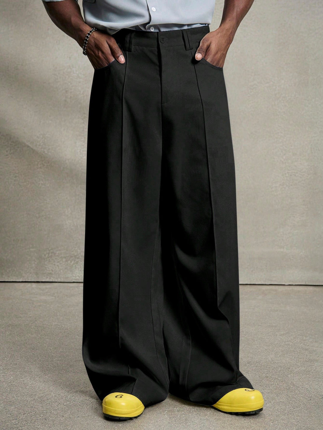 Men's wide pleated pants with high waistband, precise creases, and side inset pockets Mune Fashion
