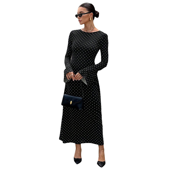 Women's elegant polka-dot maxi dress with fitted bodice, trumpet sleeves, and flowing A-line skirt.