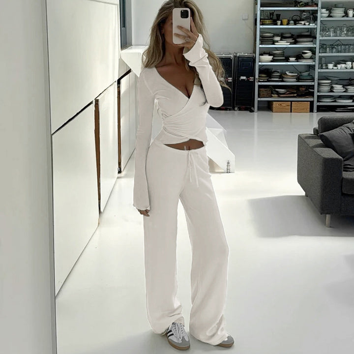 Women's wrap cropped top with deep V-neck, fitted wrap shape, and long bell sleeves Mune Fashion