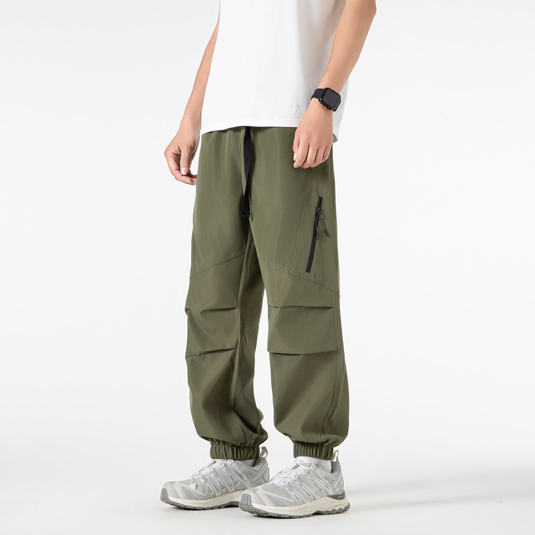 Men's loose technical cargo jogger pants with elastic drawstring waistband, patch flap pockets, and zippered leg pocket Drune