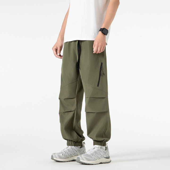 Men's loose technical cargo jogger pants with elastic drawstring waistband, patch flap pockets, and zippered leg pocket Drune