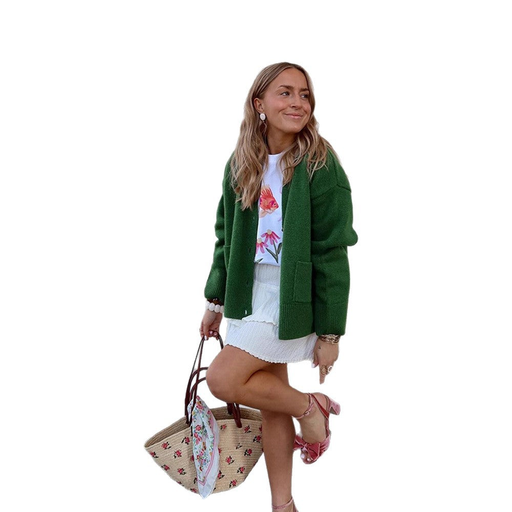 Women's oversized knit cardigan with decorative button placket, patch pockets, and elongated cuffs Mune Fashion