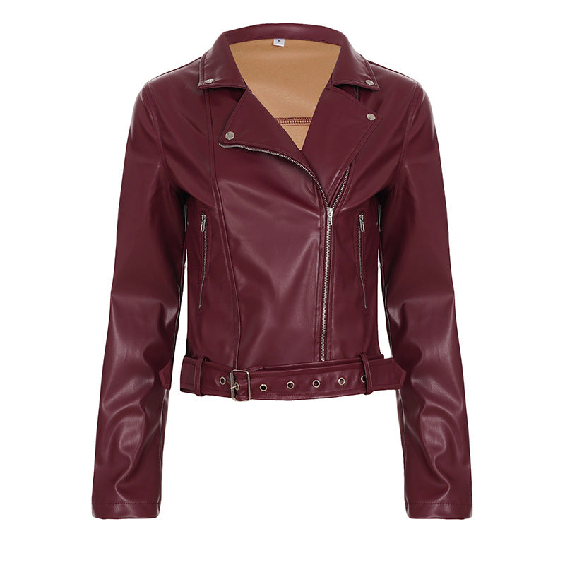 Women's fitted biker jacket made of faux leather with asymmetrical zipper, metallic details, and waist belt Mune Fashion