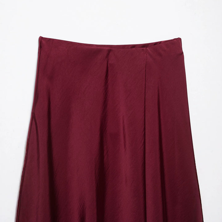 Women's flowy midi skirt in satin look with high waistband and asymmetrical hem Mune Fashion