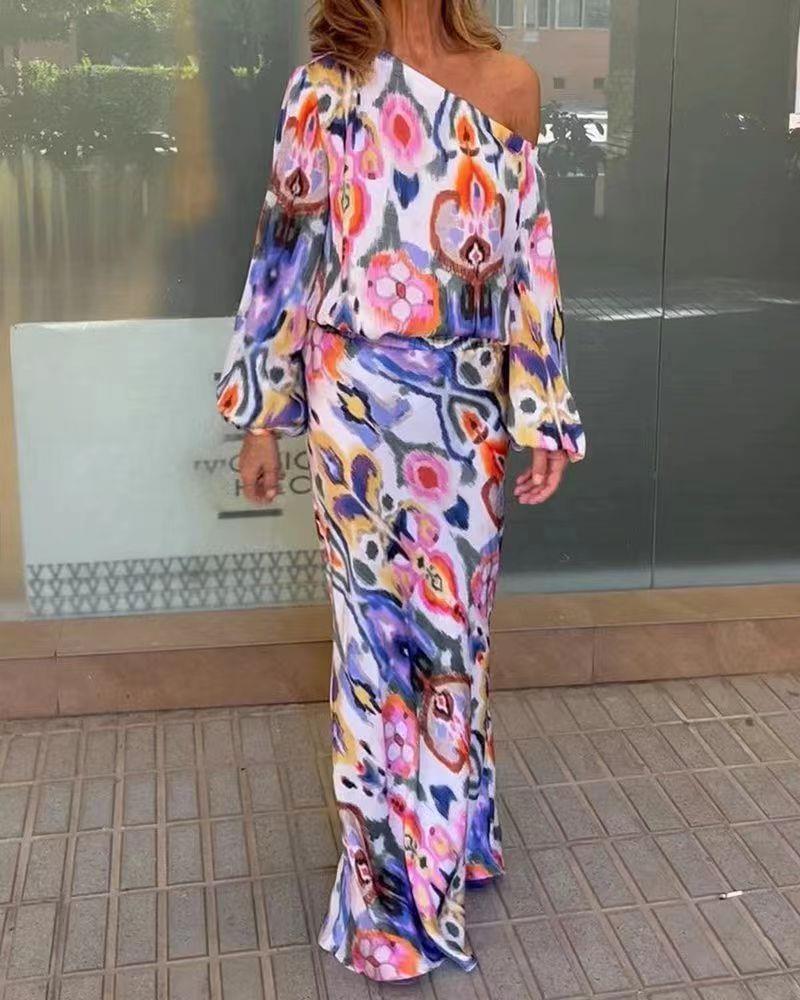 Women’s maxi dress with asymmetric one-shoulder, wide trumpet sleeves, and flowing satin print.