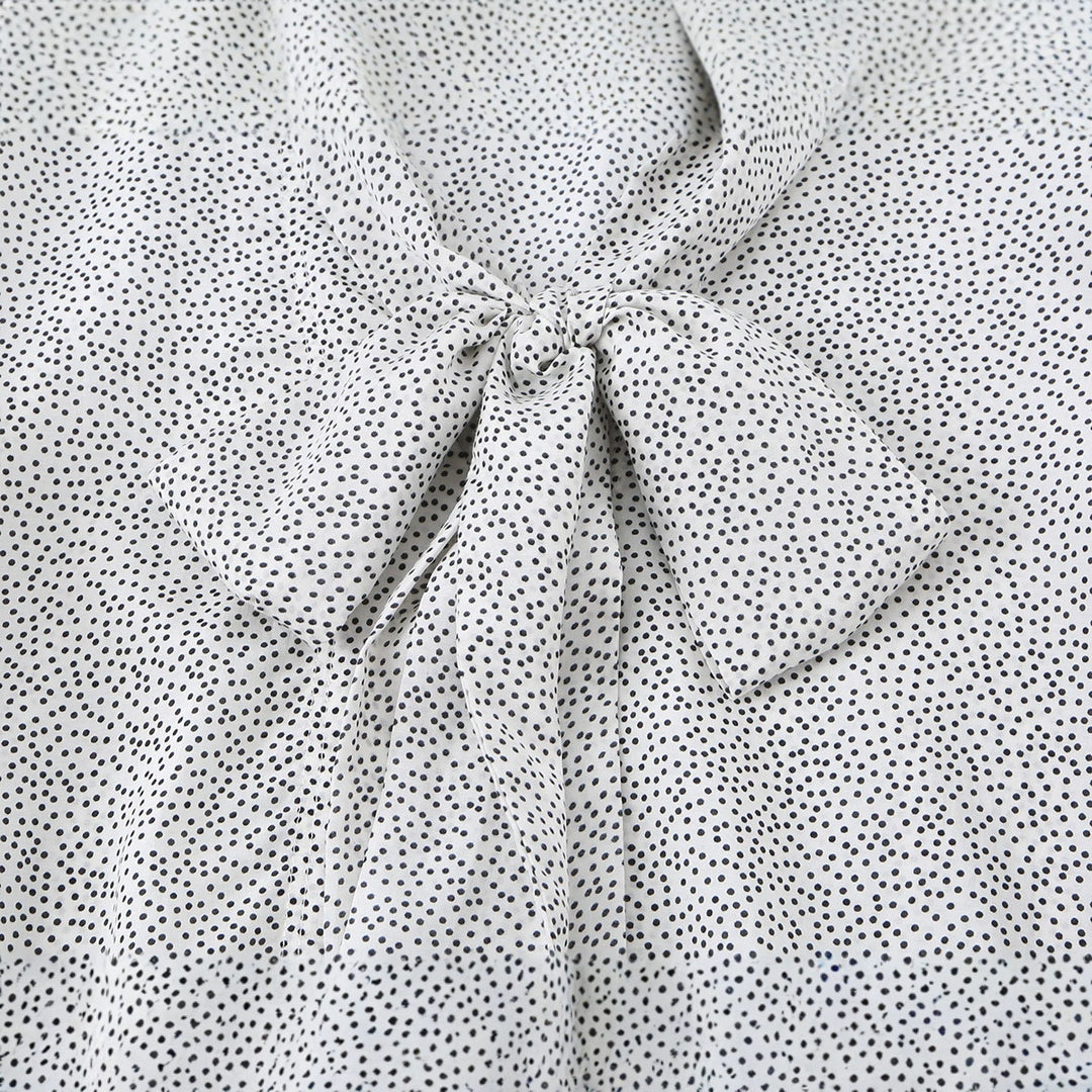 Ladies blouse with peplum and fine polka dot pattern, balloon sleeves and cuffs