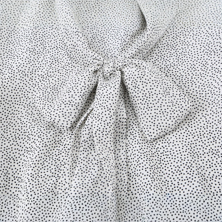 Ladies blouse with peplum and fine polka dot pattern, balloon sleeves and cuffs