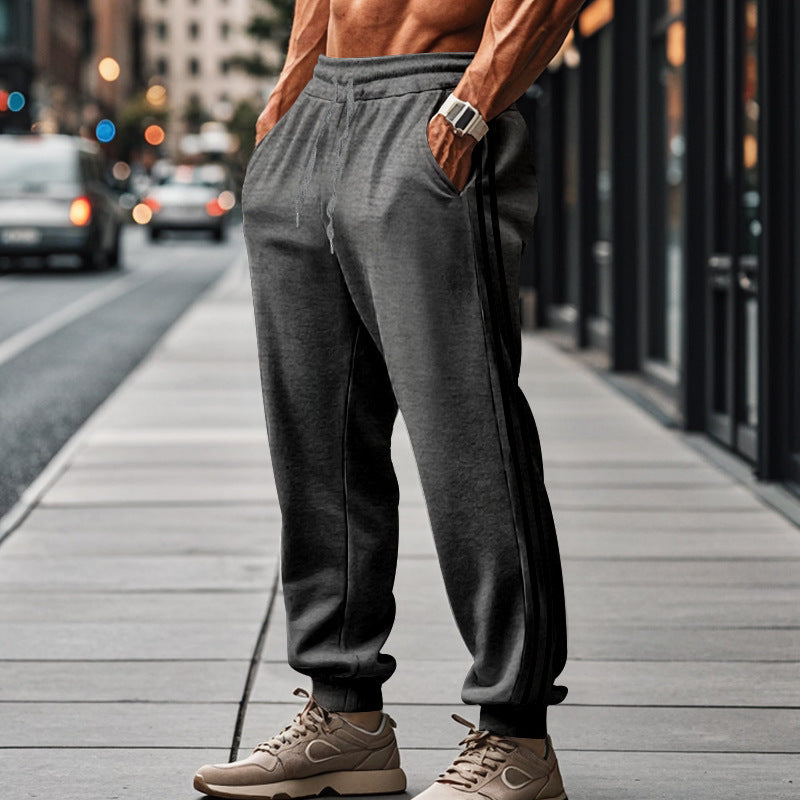 Men's sporty jogging pants with side contrast stripes, elastic drawstring waistband, and ribbed leg endings Mune Fashion