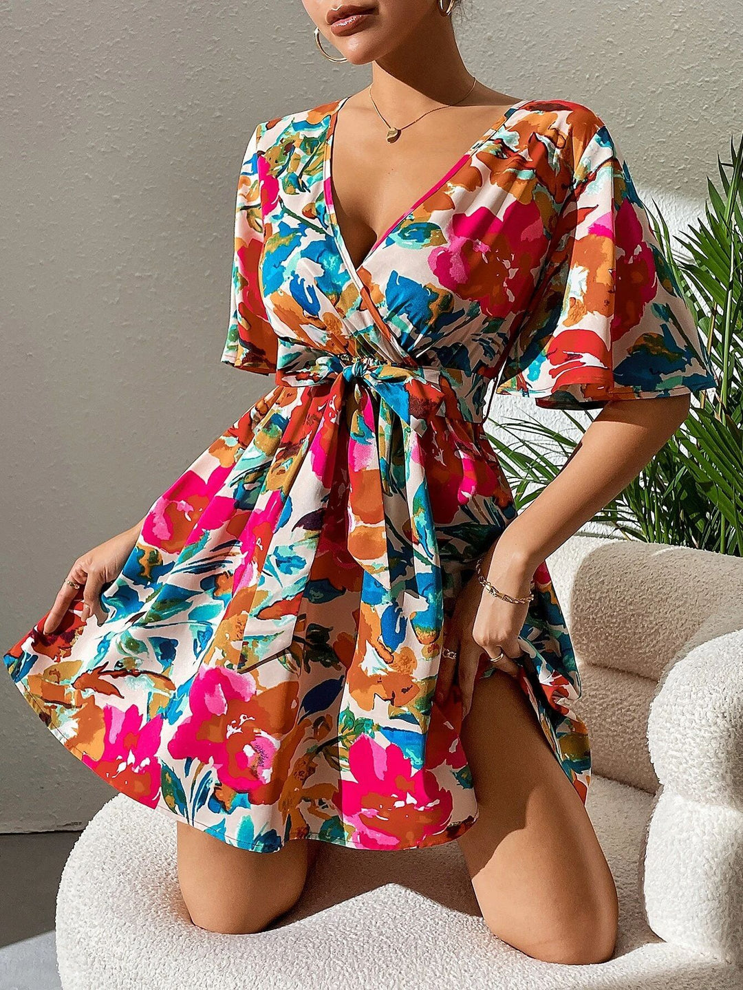 Women's wrap mini dress with deep V-neck, waist lacing, and wide trumpet sleeves Mune Fashion