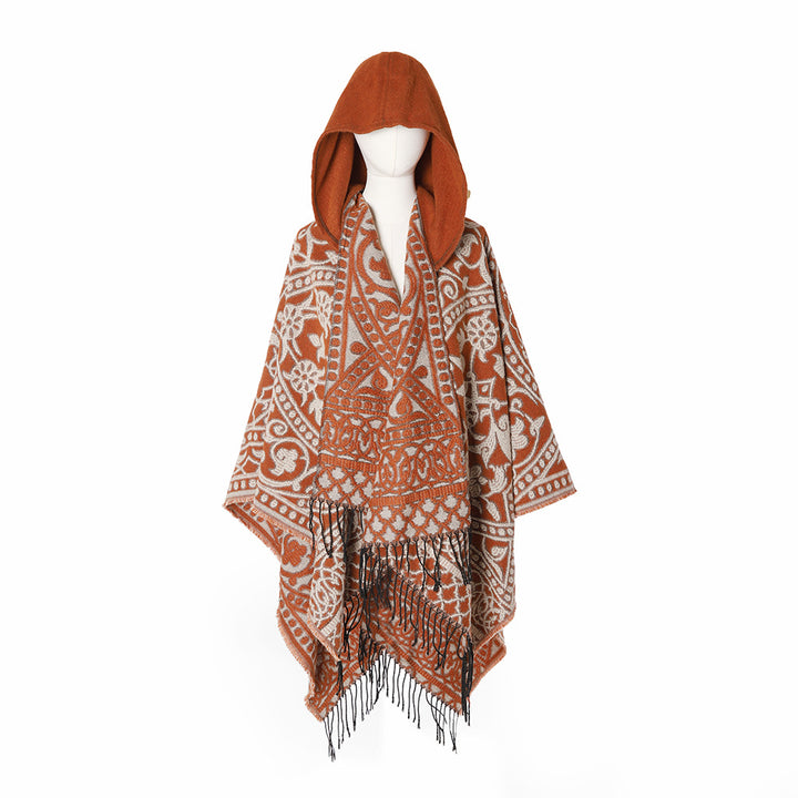Women’s hooded cape poncho made of wool blend with jacquard pattern, fringes and oversized drape.