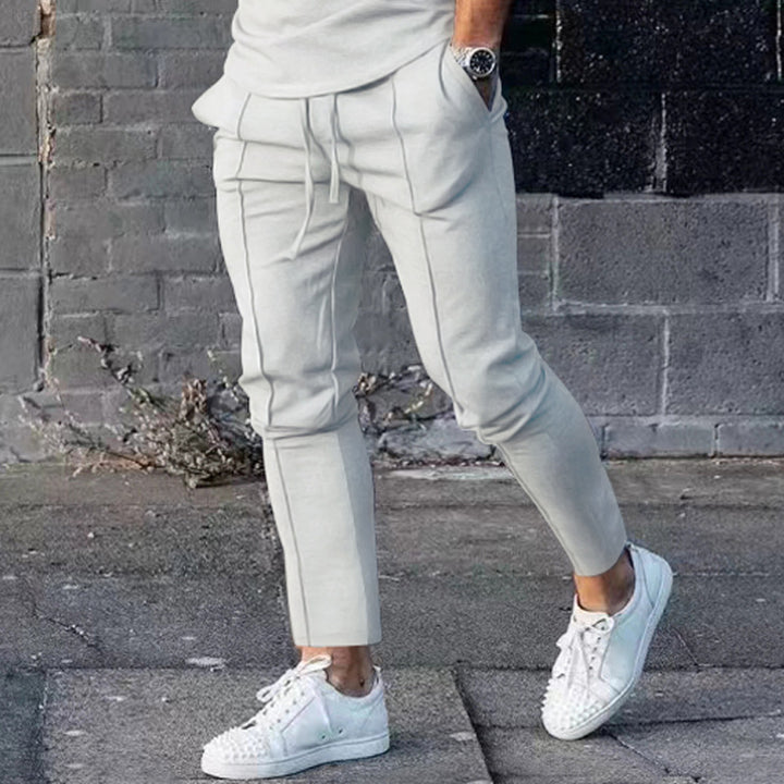 Men's Slim Tapered Jogging Pants with decorative stitching, elastic drawstring, and narrow ankle cuffs Mune Fashion