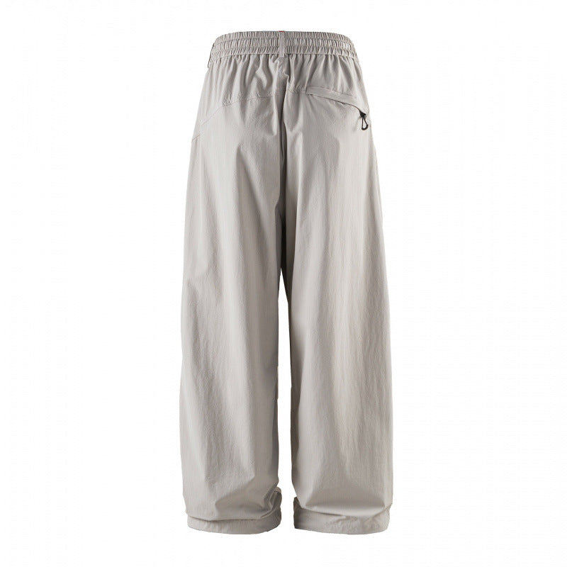 Unisex Loose-fitting technical cargo pants with elastic waistband, drawstring, and zip pockets Mune Fashion