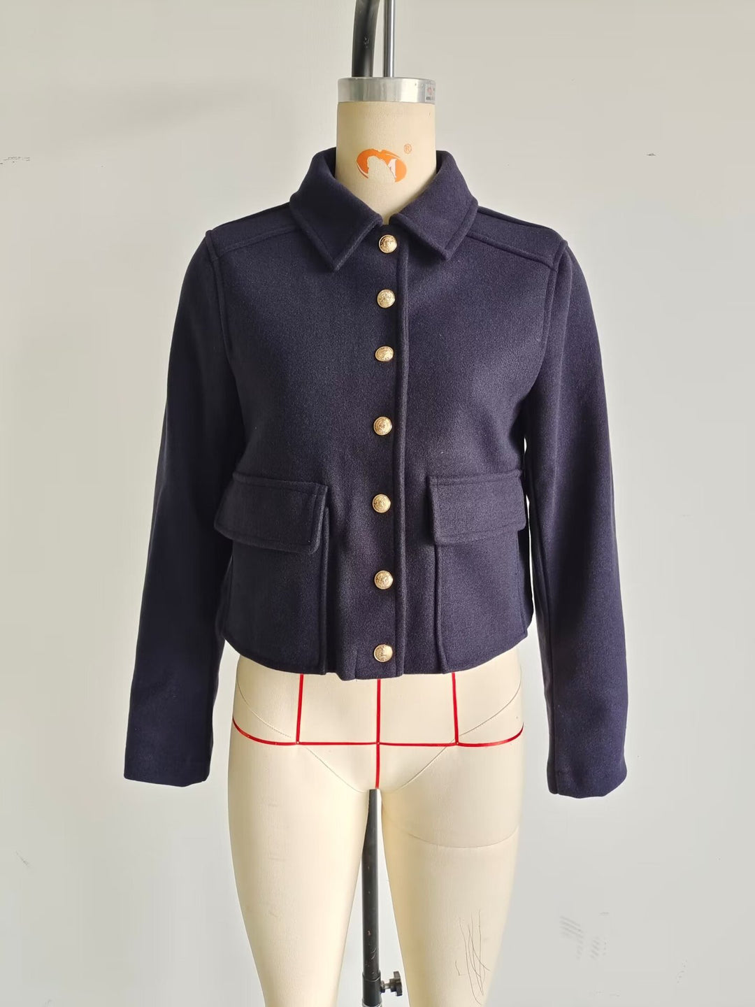 Women's short wool jacket with gold button front, patch flap pockets, and tailored silhouette Mune Fashion