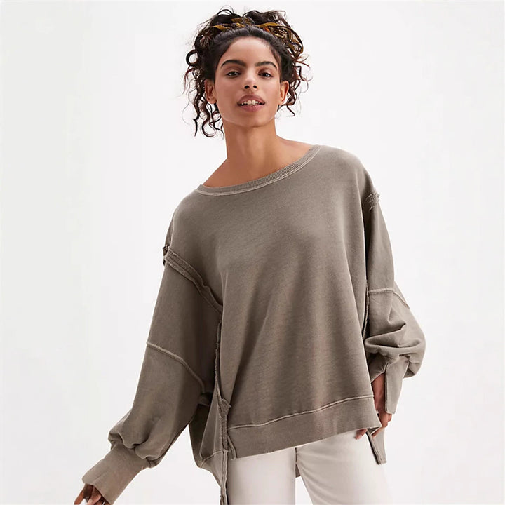Women's oversized sweatshirt with balloon sleeves, open seam stitches, and side slits Mune Fashion