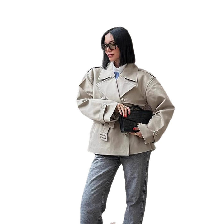 Women's short trench-style jacket with a tailored tie belt and wide sleeves Mune Fashion