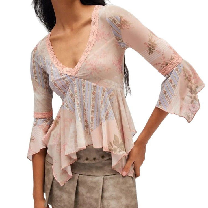 Ladies sheer mesh top with V-neck, lace trim, asymmetric ruffle hem, and bell sleeves Mune Fashion