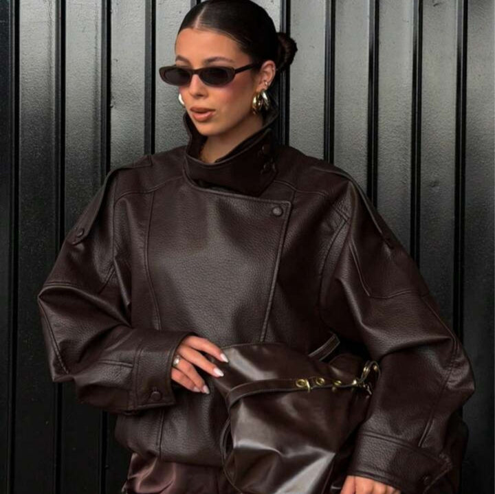 Ladies oversized biker jacket faux leather look with high stand-up collar, asymmetrical snap button front, shoulder straps and elastic hem Mune Fashion