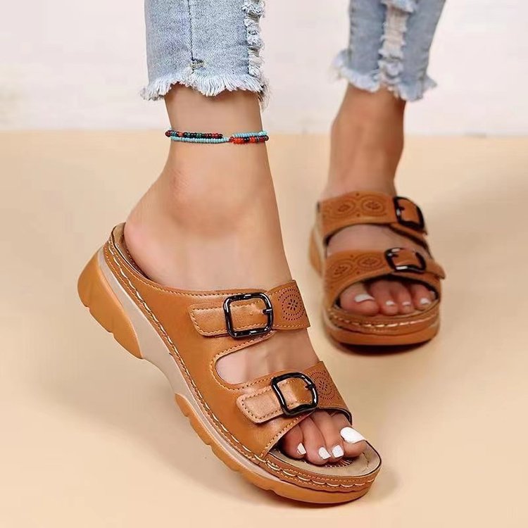 Women's double-strap slide with laser perforation, adjustable metal buckles, and padded wedge footbed Mune Fashion