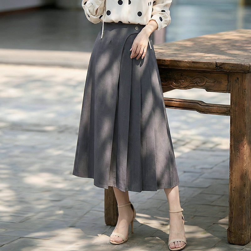 Women's high-waisted A-line skirt with asymmetrical pleats and decorative button closure Mune Fashion