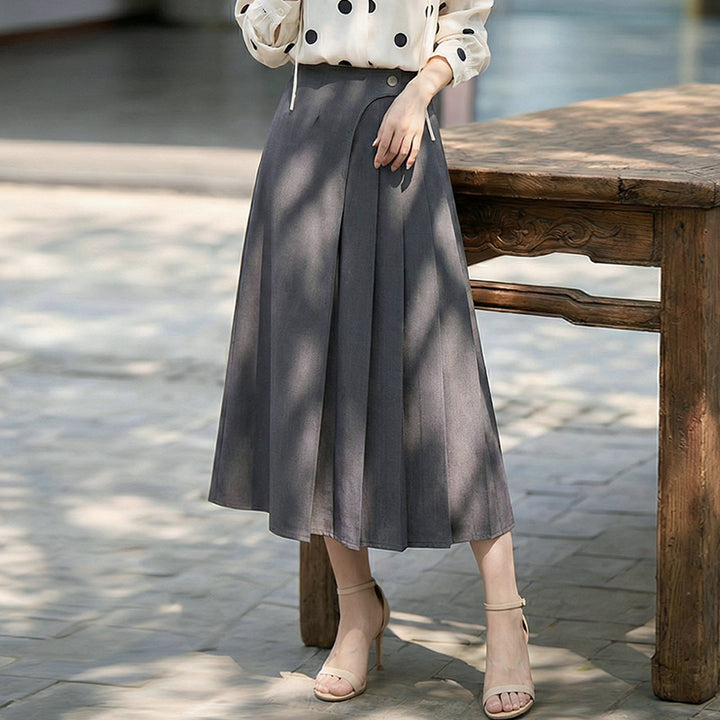 Women's high-waisted A-line skirt with asymmetrical pleats and decorative button closure Mune Fashion