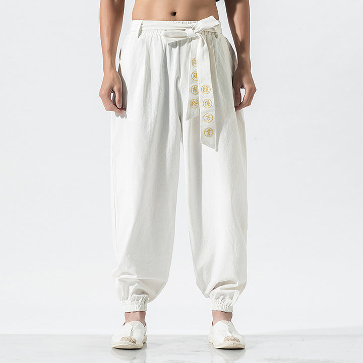 Women's wide linen trousers with drawstring waistband, binding detail, and elastic ankle cuffs Mune Fashion