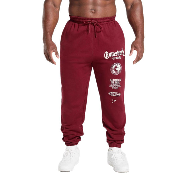 Men's tapered cotton fleece sweatpants with an elastic drawstring waistband, ribbed leg openings, and large logo print Mune Fashion