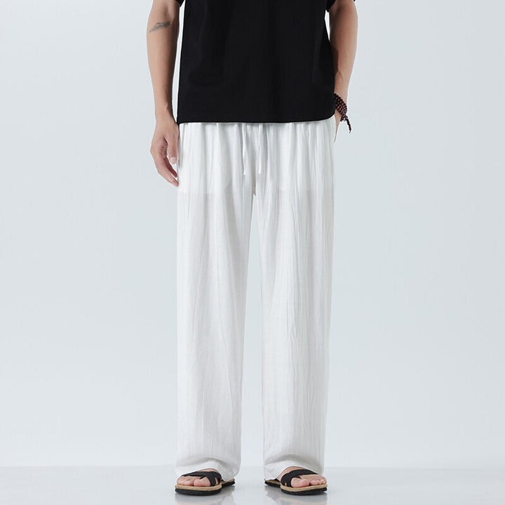 Men's loose linen trousers with adjustable drawstring waistband, casual pleat look, and side pockets Mune Fashion