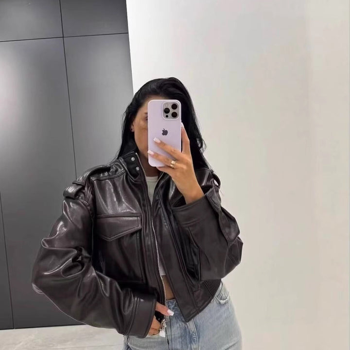 Women Short-Cut Leather Bomber with High Stand Collar, Shoulder Straps and Flap Pockets Mune Fashion