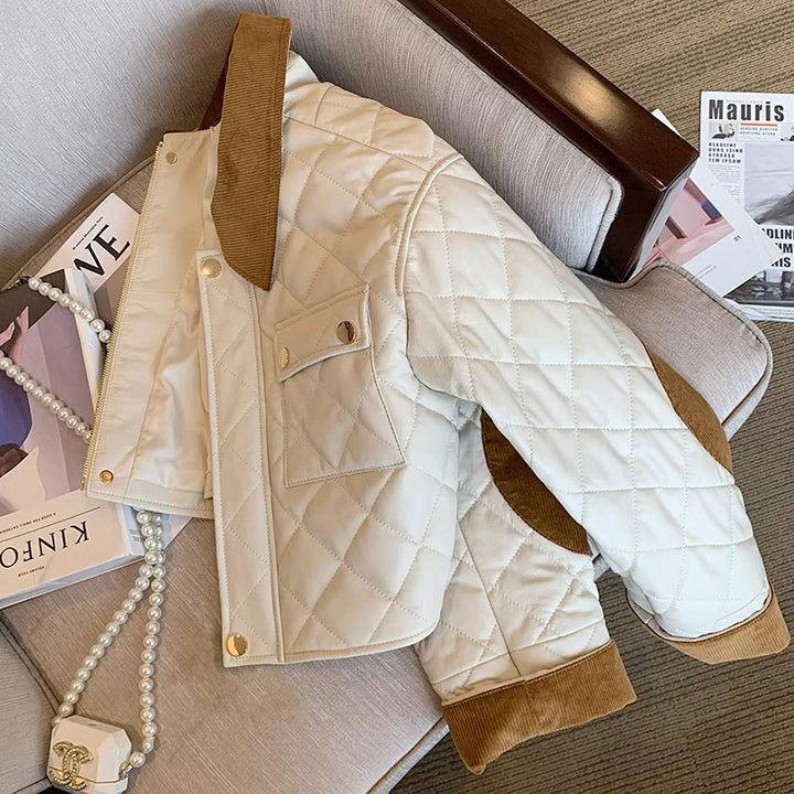 Women's quilted short bomber jacket with cord collar, snap button closure, and flap pockets