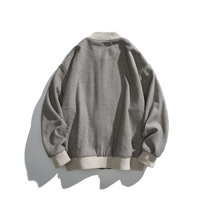 Unisex boxy bomber jacket in herringbone look with ribbed cuffs, flap pockets, and concealed snap button placket Mune Fashion