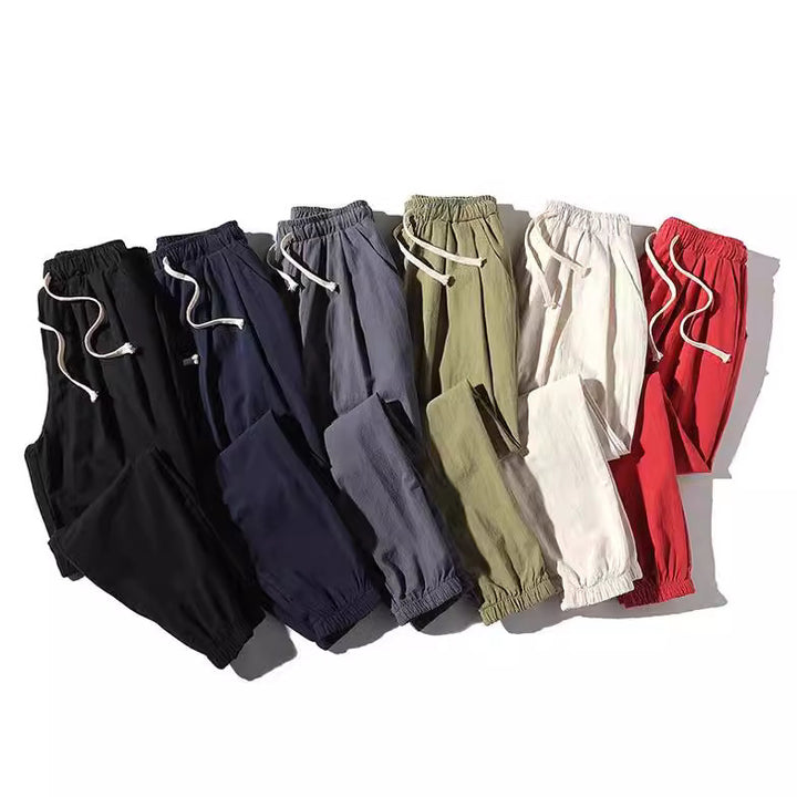 Men's loose joggers with elastic waistband, drawstring, side pockets, and elastic cuffs Mune Fashion