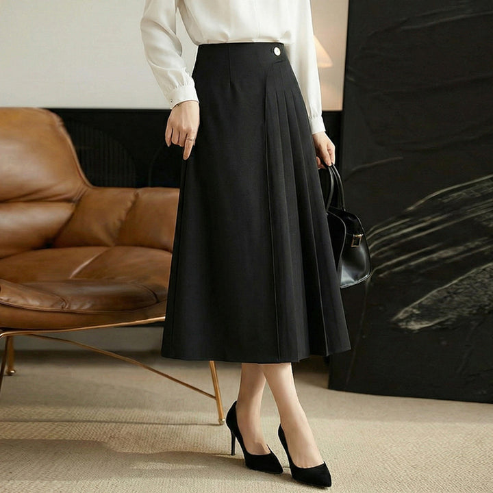 Women's high-waisted A-line skirt with asymmetrical pleats and decorative button closure Mune Fashion