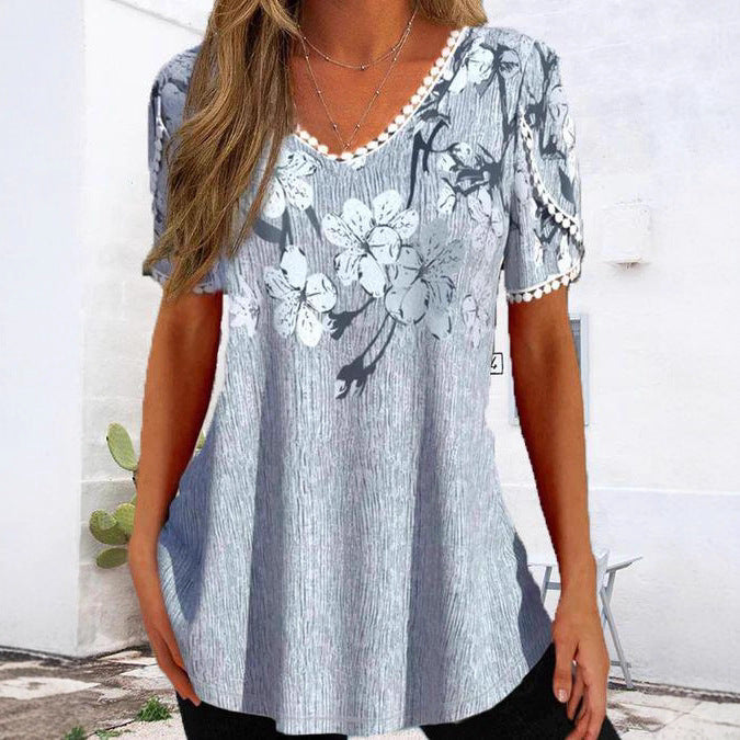 Women's flowing V-neck tunic top with floral print pompom trim and A-line cut Mune Fashion