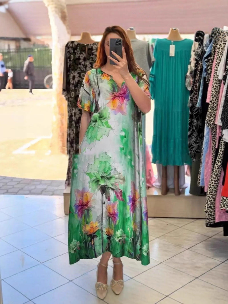Women flowing maxi kaftan dress with V-neck and large watercolor floral print Mune Fashion