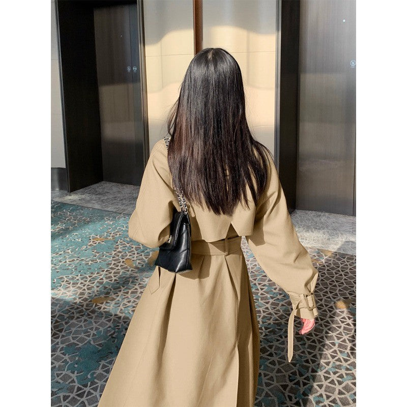 Women's elegant midi trench coat with oversized shoulder flap, gathered sleeves, and waist-defining tie belt Mune Fashion