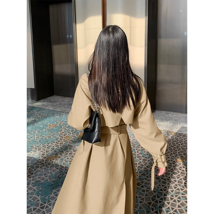 Women's elegant midi trench coat with oversized shoulder flap, gathered sleeves, and waist-defining tie belt Mune Fashion