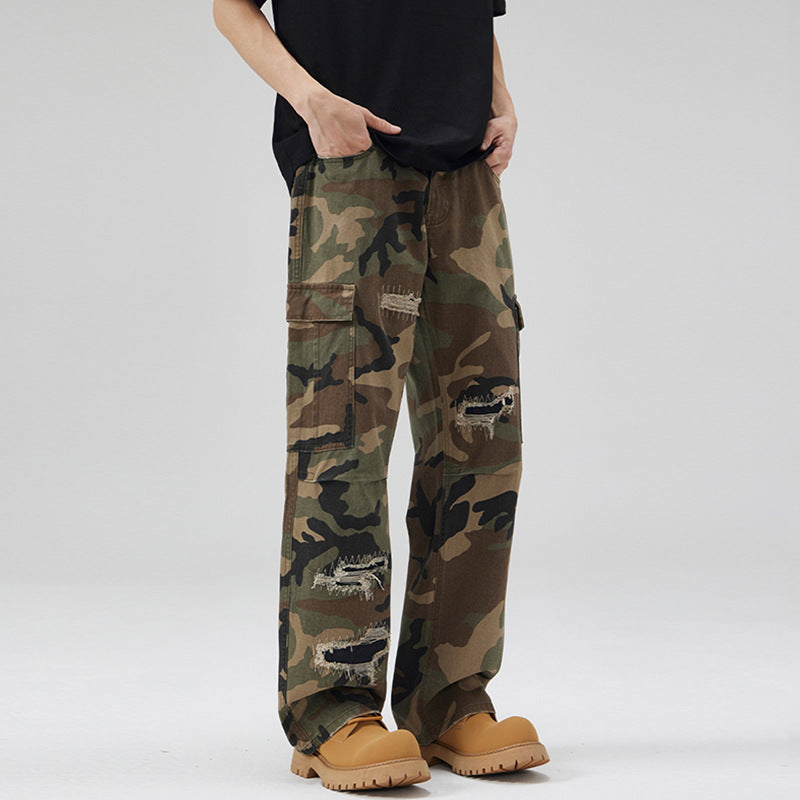 Men's loose cargo pants in camouflage look with deliberately ripped details and large flap pockets Mune Fashion