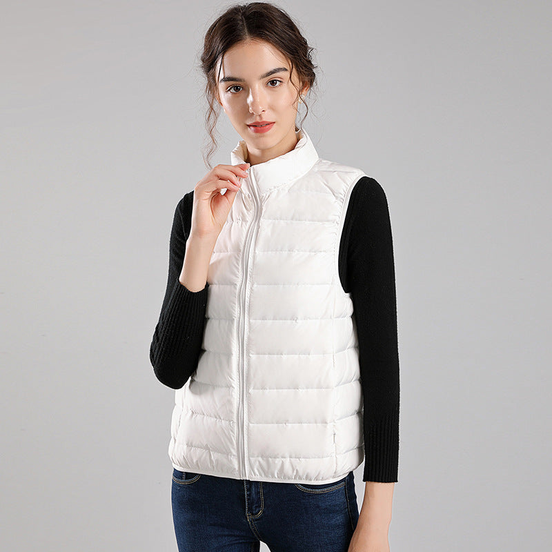 Women's packable quilted vest with flat down look, stand-up collar and side slip pockets Mune Fashion