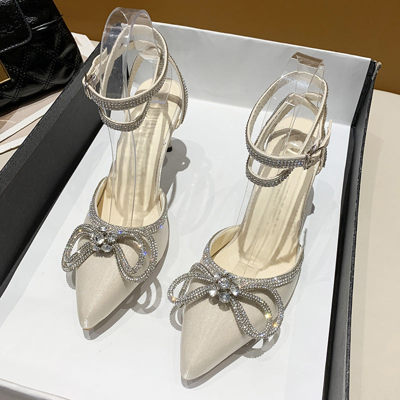 Women's pointed strap pumps with sparkling rhinestone bow appliqué and adjustable ankle strap Mune Fashion
