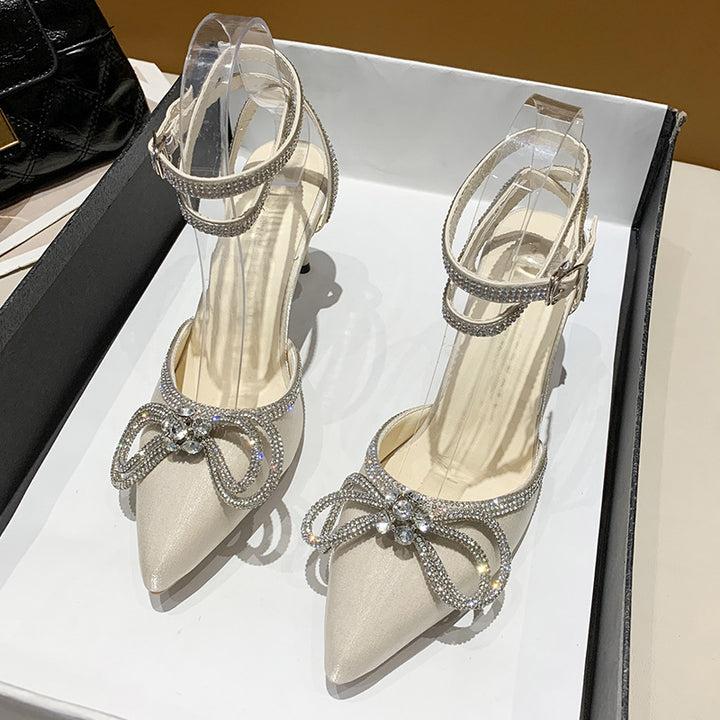 Women's pointed strap pumps with sparkling rhinestone bow appliqué and adjustable ankle strap Mune Fashion