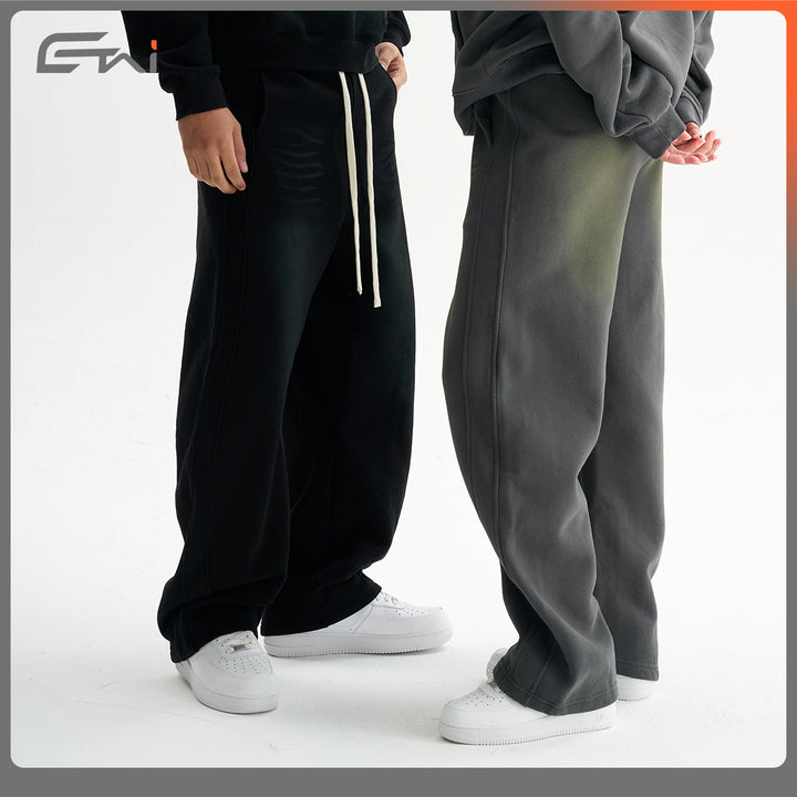 Men's baggy sweatpants with low crotch, contrasting decorative seams, and extra long drawstrings.