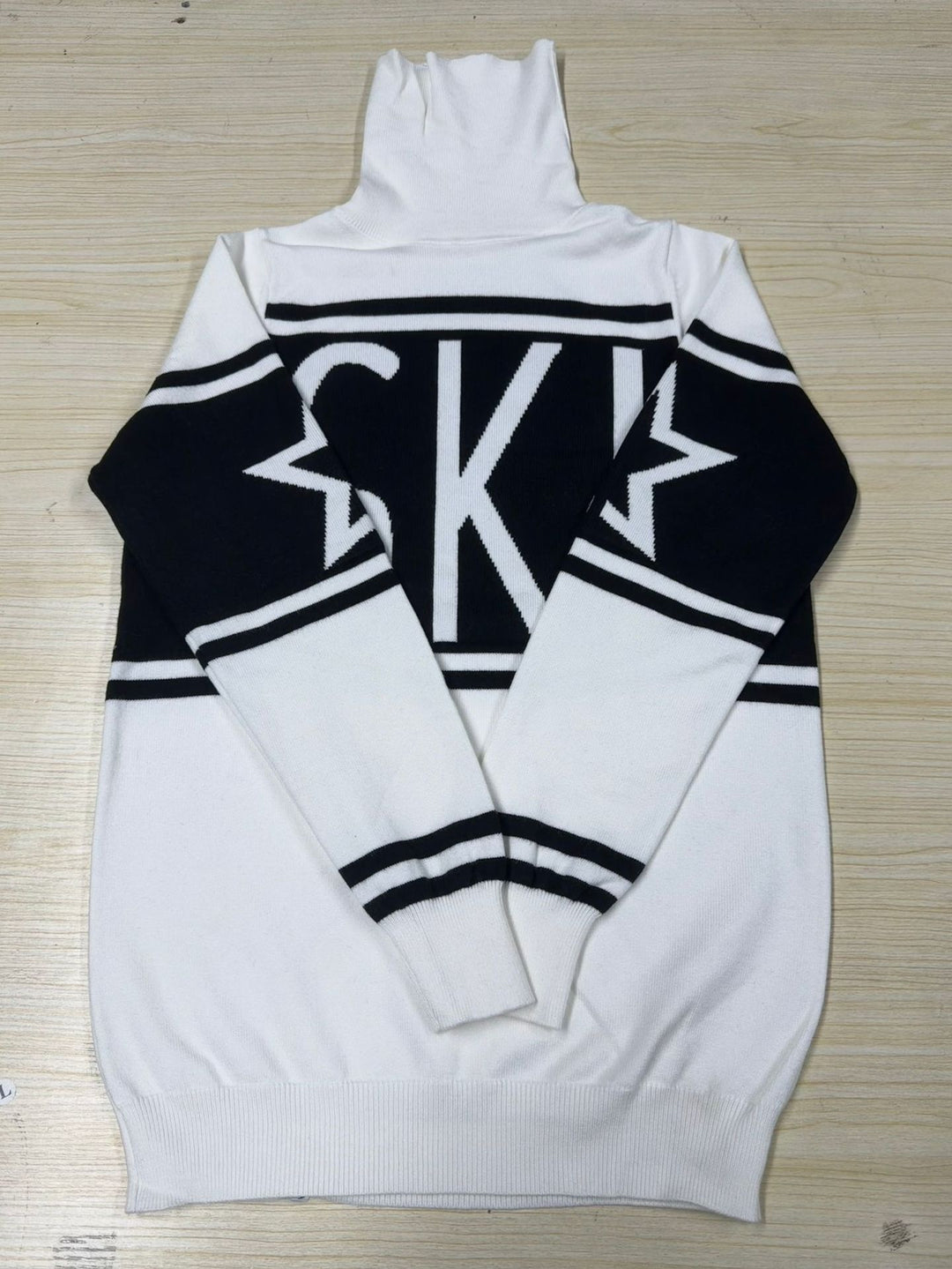 Women's long turtleneck knit dress with star motif, block stripes and elastic ribbed hem