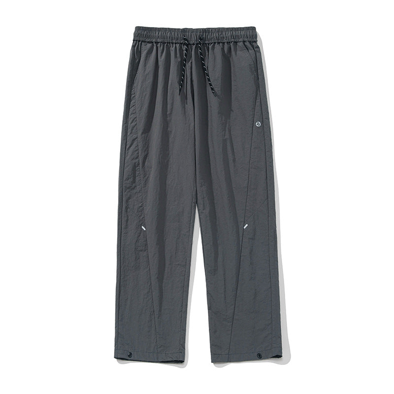 Unisex Wide water-repellent nylon leisure pants with elastic waistband and snap-button hem Mune Fashion
