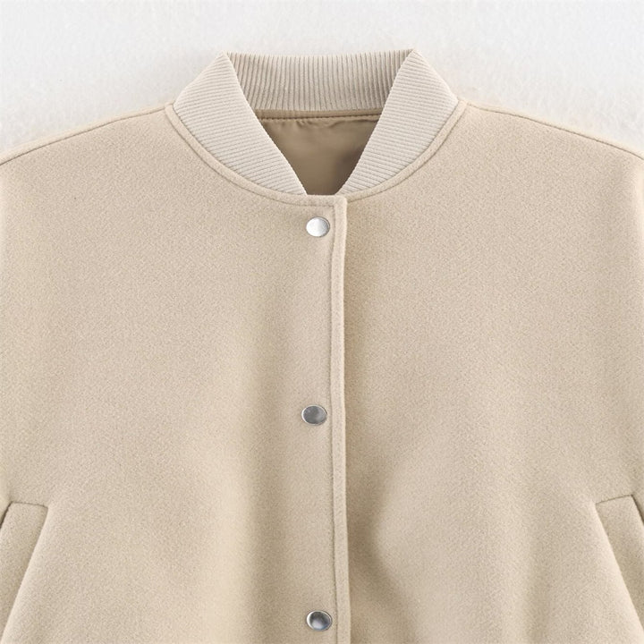 Ladies short boxy bomber jacket with ribbed collar, snap button closure, and pockets Mune Fashion