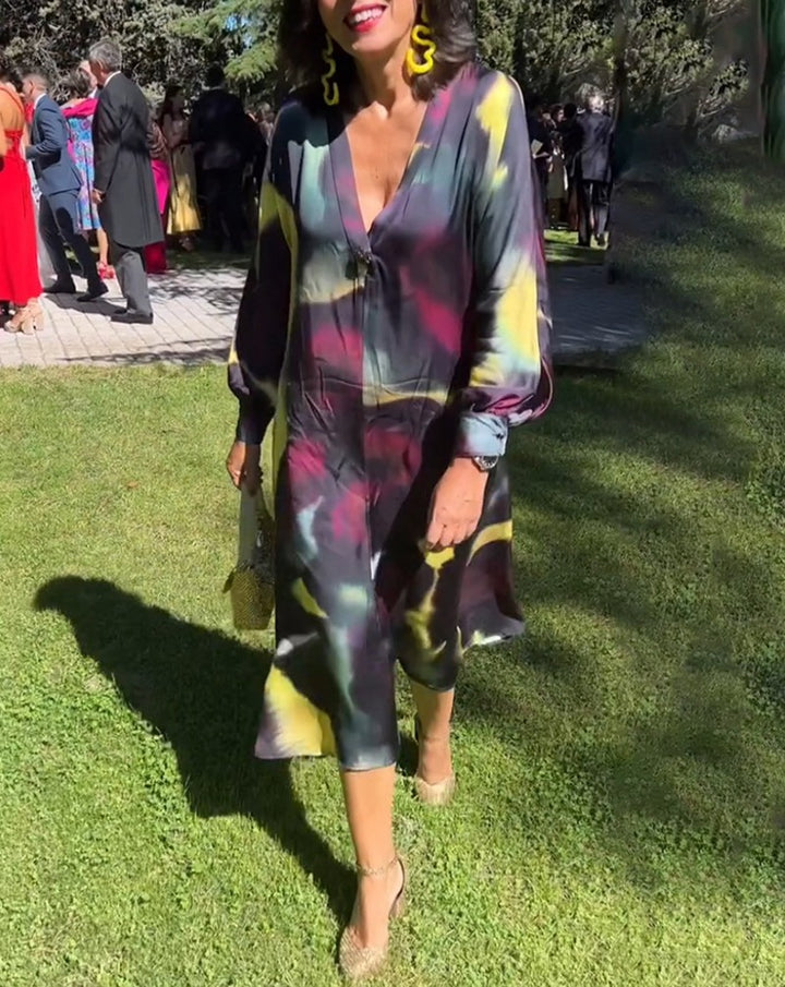 Women's flowing midi dress with abstract print, V-neckline, balloon sleeves, and decorative closure Mune Fashion